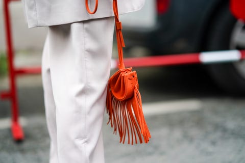 Street Style At Paris Fashion Week - Womenswear Spring Summer 2021 : Day Three paris, france september 30 a guest wears an orange bag with fringes, outside kenzo, during paris fashion week womenswear spring summer 2021, on september 30, 2020 in paris, france photo by edward berthelotgetty images