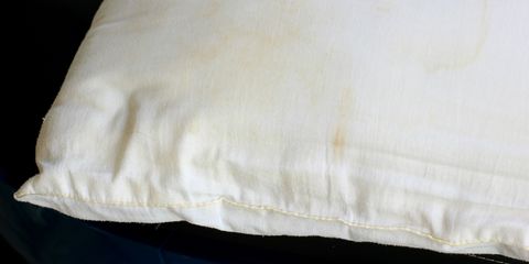 white old pillow with dirty stain selective focus