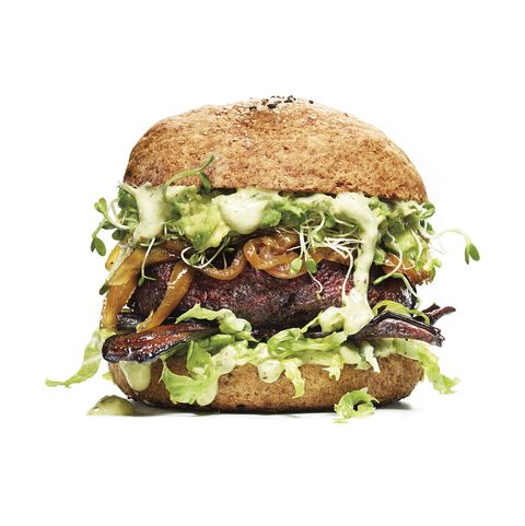 veggie burger with gluten free bun avocado, caramelized onion, on white background