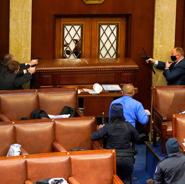 washington, dc   january 06 us capitol police officers point their guns at a door that was vandalized in the house chamber during a joint session of congress on january 06, 2021 in washington, dc congress held a joint session today to ratify president elect joe bidens 306 232 electoral college win over president donald trump a group of republican senators said they would reject the electoral college votes of several states unless congress appointed a commission to audit the election results photo by drew angerergetty images