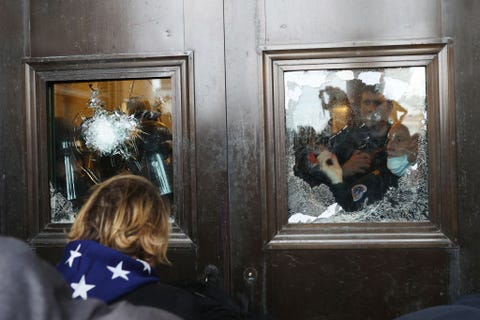 Trump Supporters Hold "Stop The Steal" Rally In DC Amid Ratification Of Presidential Election washington, dc january 06 a capitol police officer looks out of a broken window as protesters gather on the us capitol building on january 06, 2021 in washington, dc pro trump protesters entered the us capitol building after mass demonstrations in the nations capital during a joint session congress to ratify president elect joe bidens 306 232 electoral college win over president donald trump photo by tasos katopodisgetty images