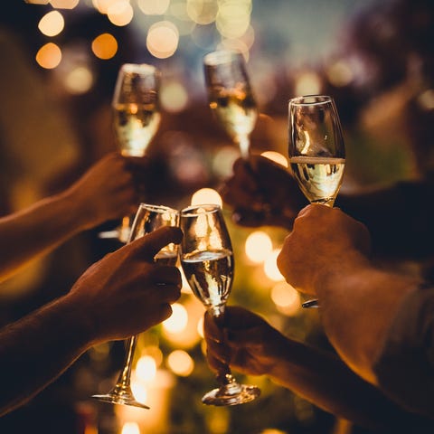 Birthday Celebratory Toast with String Lights and Champagne Silhouettes numerous hands holding champagne flutes with champagne celebratory toast silhouettes