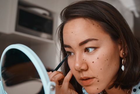 shot of a beautiful young woman applying eyeliner during her beauty routine at home