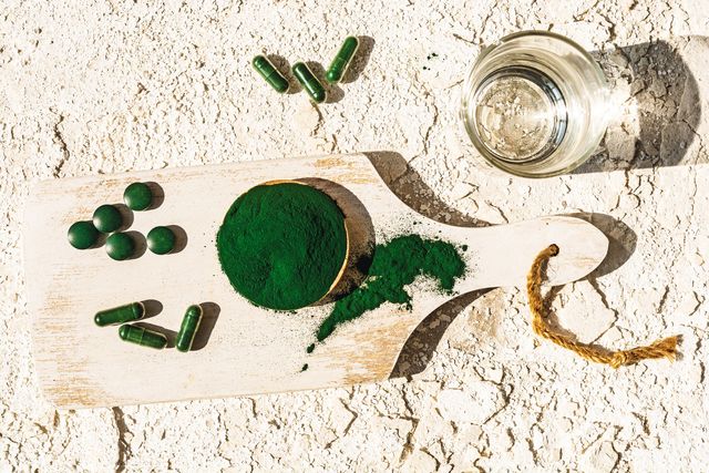 green algae powder, pills and capsules still life high angle view