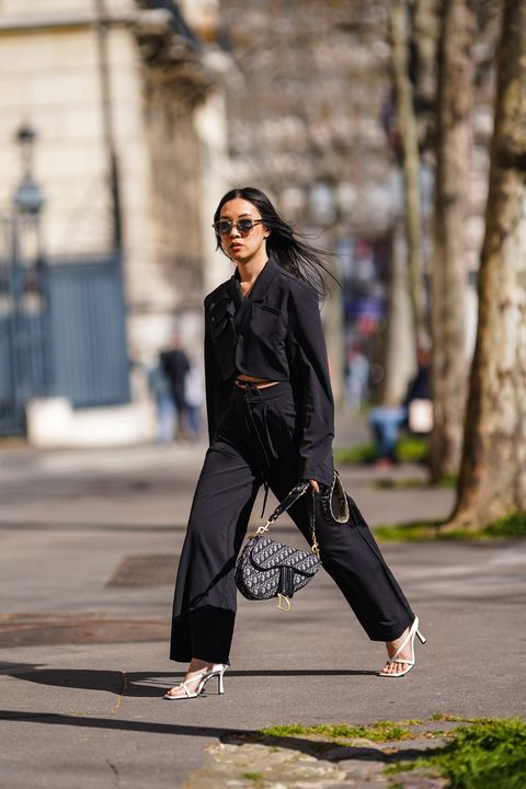 paris, alessandra huynh atiashuynh wears sunglasses, a black cropped double breasted oversized jacket with flare sleeves from zara, a dior saddle bag with printed monograms, vintage black flare pants, white sandals from zara