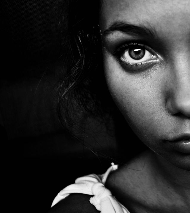 square cropped black and white portrait of girl with big eyes wearing white dress