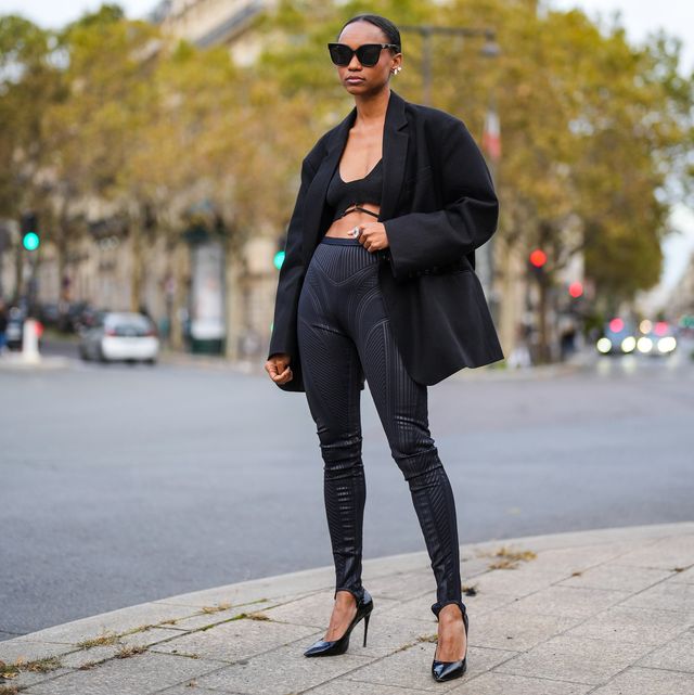 paris, france   october 17 emilie joseph infashionwetrust wears an oversized boyfriend blazer jacket by frankie shop, a black wool crop top  bras, shiny embossed stirrups leggings from thierry mugler, black high heels shiny pointed shoes, on october 17, 2021 in paris, france photo by edward berthelotgetty images