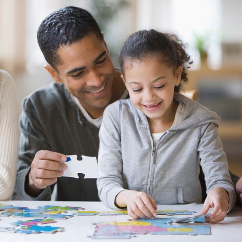 Family putting together puzzle family putting together puzzle