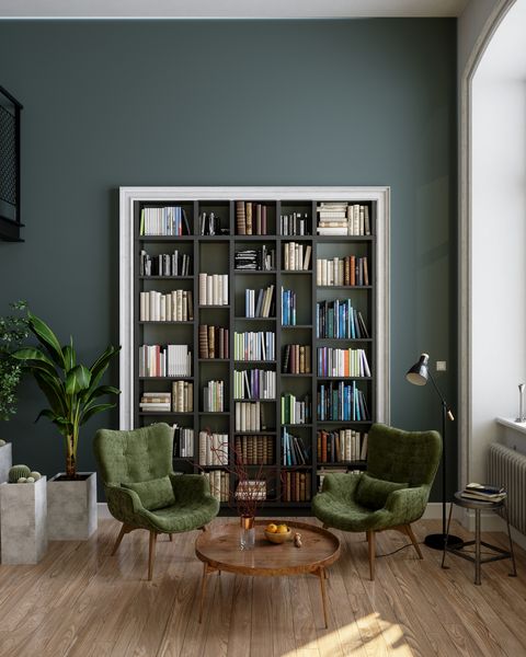 reading room interior with bookshelf, green armchairs, coffee table and potted plants