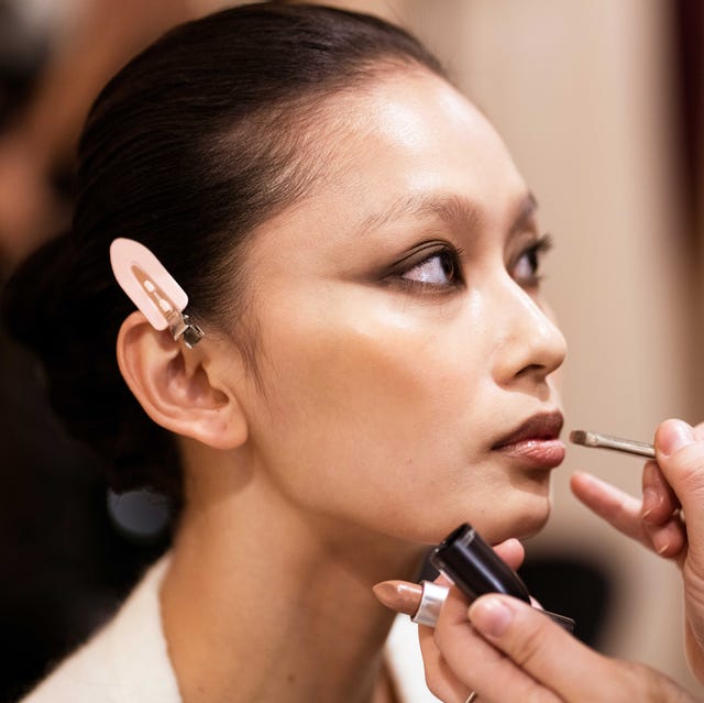 model getting her makeup done