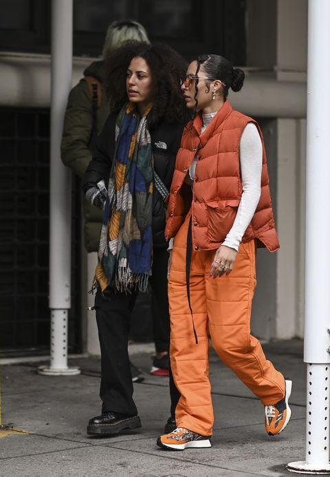 new york, new york   february 16 a guest is seen wearing an orange puff vest, white top and orange pants outside the collina strada show during new york fashion week aw 2022 on february 16, 2022 in new york city photo by daniel zuchnikgetty images
