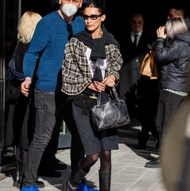 Street Style - Day 2 - Milan Fashion Week Fall/Winter 2022/2023 milan, italy february 24 model bella hadid is seen wearing chanel bag, checkered scarf, grey skirt, sheer tights, knee high boots in black outside max mara fashion show during the milan fashion week fallwinter 20222023 on february 24, 2022 in milan, italy photo by christian vieriggetty images