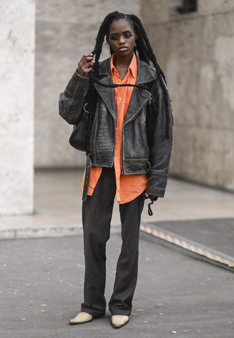 paris, france   march 02 a model is seen wearing a vintage jacket, orange shirt and brown pants outside rochas show during paris fashion week aw 2022 on march 02, 2022 in paris, france photo by daniel zuchnikgetty images