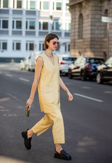 berlin, germany   march 15 jacqueline zelwis is seen wearing yellow lovechild sleeveless dress  pants, black loafers billi bi, ray ban sunglasses, green bag octogony during berlin fashion week on march 15, 2022 in berlin, germany photo by christian vieriggetty images