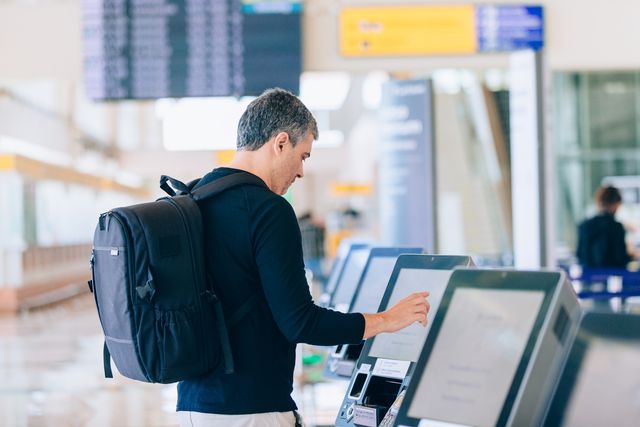 man using check in airport counter