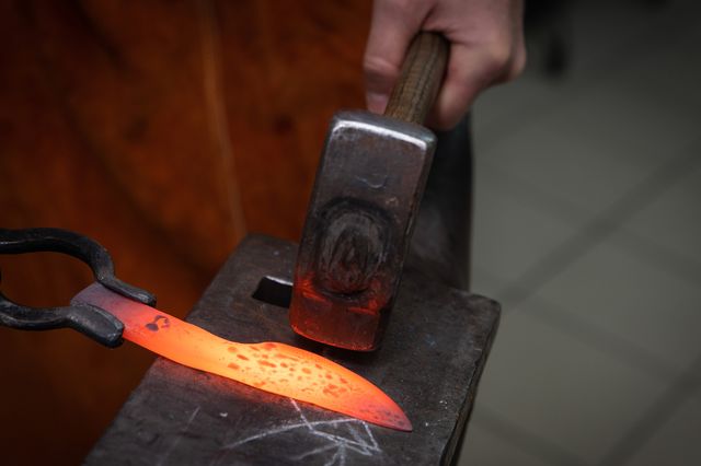man hands manufacturing a steel knife