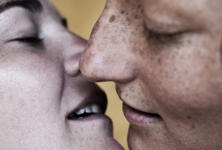 Close up of Caucasian lesbians kissing