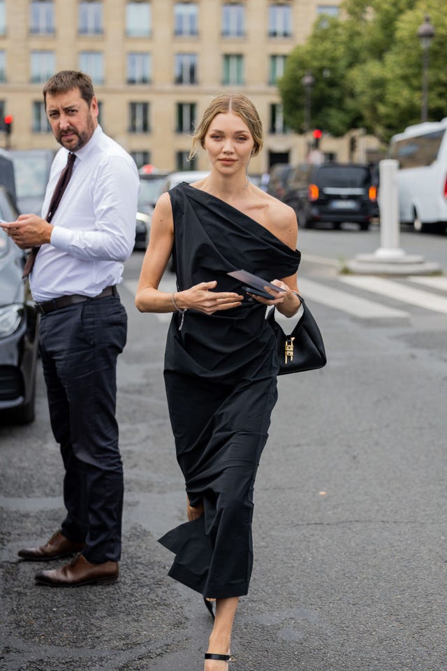 Black dress with asymmetrical neckline in the street style of Paris black dress with asymmetrical neckline in the street style of paris