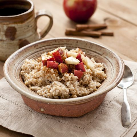 Breakfast made of oatmeal with apples, honey and cinnamon