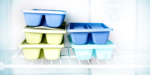 Stacked ice cube trays in a freezer