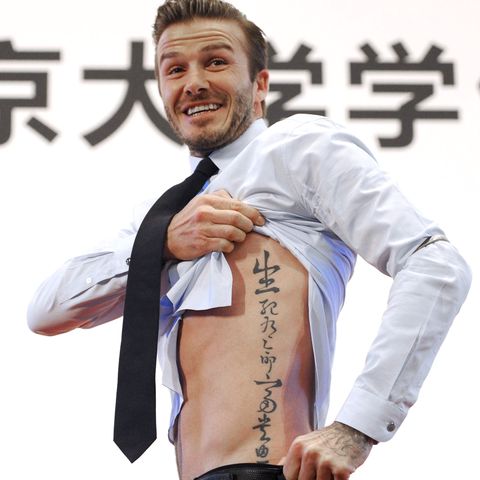 beijing, china   march 24  china out british football player david beckham shows his tattoo to fans during his visit to peking university on march 24, 2013 in beijing, china david beckham is on a five day visit to china at the invitation of the china football association as chinas first international ambassador photo by visual china group via getty imagesvisual china group via getty images