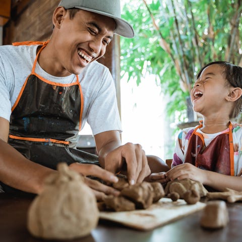 pottery workshop a potter craftsman shows his child how to work with clay pottery workshop a potter craftsman shows his child how to work with clay