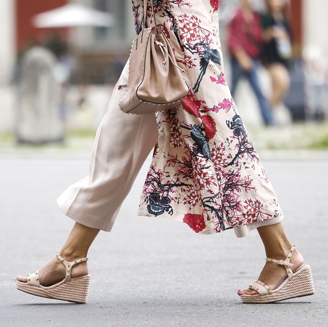 munich, germany   july 27 a pastel pink rockstud bag with gold studs by valentino and pastel pink ankle strap rockstud wedge sandals with gold studs by valentino as a detail of influencer jeannette graf during a street style shooting on july 27, 2021 in munich, germany photo by streetstyleshootersgetty images