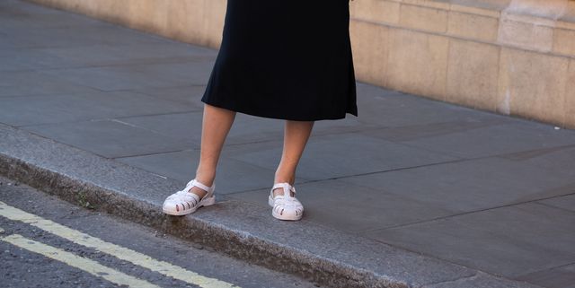 london, england   september 15 model ling chen wears airpods, a blue blouse, black skirt, and light pink jelly sandals after the emilia wickstead show during london fashion week september 2019 on september 15, 2019 in london, england photo by melodie jenggetty images