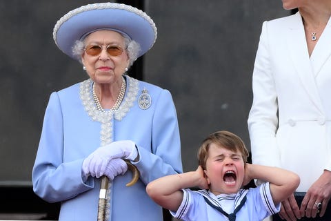 topshot   britains prince louis of cambridge r holds his ears as he stands next to britains queen elizabeth ii to watch a special flypast from buckingham palace balcony following the queens birthday parade, the trooping the colour, as part of queen elizabeth iis platinum jubilee celebrations, in london on june 2, 2022   huge crowds converged on central london in bright sunshine on thursday for the start of four days of public events to mark queen elizabeth iis historic platinum jubilee, in what could be the last major public event of her long reign photo by daniel leal  afp photo by daniel lealafp via getty images