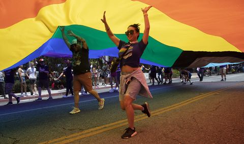 volunteers keep the pride flag aloft during the west hollywood pride parade in west hollywood