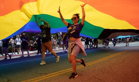 pride parade volunteers keep the pride flag aloft during the west hollywood pride parade in west hollywood