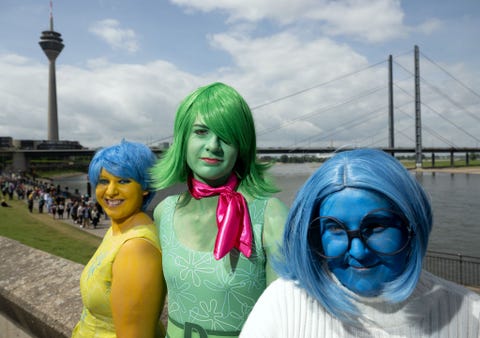 cosplayers dressed as disney characters joy, sorrow and disgust from the film inside out