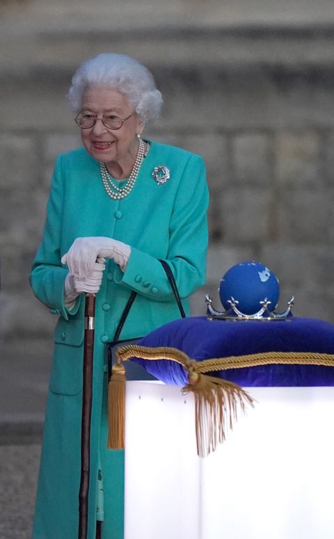 windsor, england   june 02 britains queen elizabeth ii prepares to touch the commonwealth nations globe to start the lighting of the principal beacon outside of buckingham palace in london, from the quadrangle at windsor castle in windsor, west of london, as part of platinum jubilee celebrations on june 2, 2022 in windsor, england more than 2,800 beacons are lit at buckingham palace and across the uk, including atop the four highest peaks, as well as on the channel islands, the isle of man, and british overseas territories flaming tributes will be seen in 54 commonwealth capitals across five continents, from tonga and samoa in the south pacific to belize in the caribbean the platinum jubilee of elizabeth ii is being celebrated from june 2 to june 5, 2022, in the uk and commonwealth to mark the 70th anniversary of the accession of queen elizabeth ii on 6 february 1952 photo by  steve parsons poolgetty images