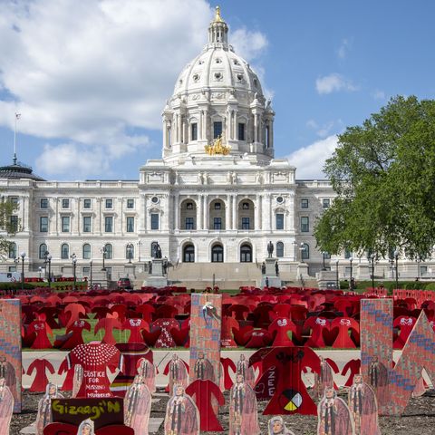 thousands of cardboard red dresses set out on the state capitol lawn in st paul to help represent what has happened historically to native american women  across the nation