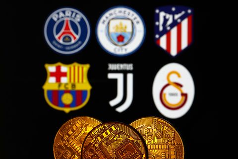 representation of cryptocurrency is seen with logos of some of the football clubs, that have their own token coins, displayed in the background in this illustration photo taken in krakow, poland on december 10, 2021 photo by jakub porzyckinurphoto via getty images