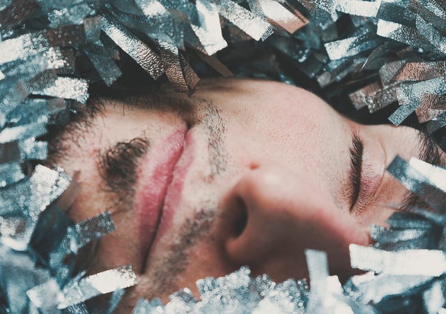 Close-Up Portrait Of Young Man in glitter men festival fashion
