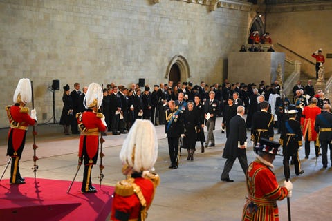 london, england   september 14 princess eugenie, princess beatrice, prince edward, earl of wessex, prince william, prince of wales, sophie, countess of wessex, catherine, princess of wales, prince harry, duke of sussex, meghan, duchess of sussex, mr peter phillips and david armstrong jones, 2nd earl of snowdon pay their respects inside the palace of westminster during the lying in state of queen elizabeth ii on september 14, 2022 in london, england queen elizabeth iis coffin is taken in procession on a gun carriage of the kings troop royal horse artillery from buckingham palace to westminster hall where she will lay in state until the early morning of her funeral queen elizabeth ii died at balmoral castle in scotland on september 8, 2022, and is succeeded by her eldest son, king charles iii  photo by david ramosgetty images