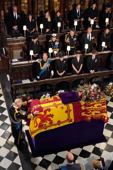 windsor, england   september 19 king charles iii places the the queens company camp colour of the grenadier guards on the coffin of queen elizabeth ii during the committal service for queen elizabeth ii at st georges chapel, windsor castle on september 19, 2022 in windsor, england the committal service at st georges chapel, windsor castle, took place following the state funeral at westminster abbey a private burial in the king george vi memorial chapel followed queen elizabeth ii died at balmoral castle in scotland on september 8, 2022, and is succeeded by her eldest son, king charles iii photo by jonathan brady   wpa poolgetty images