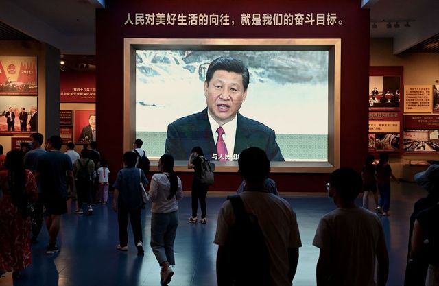 people walk past a screen showing chinese president xi jinping at the museum of the communist party of china in beijing on september 4, 2022 photo by noel celis  afp photo by noel celisafp via getty images