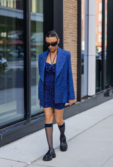 new york, new york   september 10 a guest wearing knee socks, blue blazer, dress with dots print outside tibi on september 10, 2022 in new york city photo by christian vieriggetty images