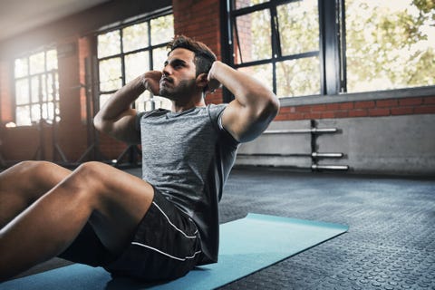 shot of a handsome young man working out at the gym