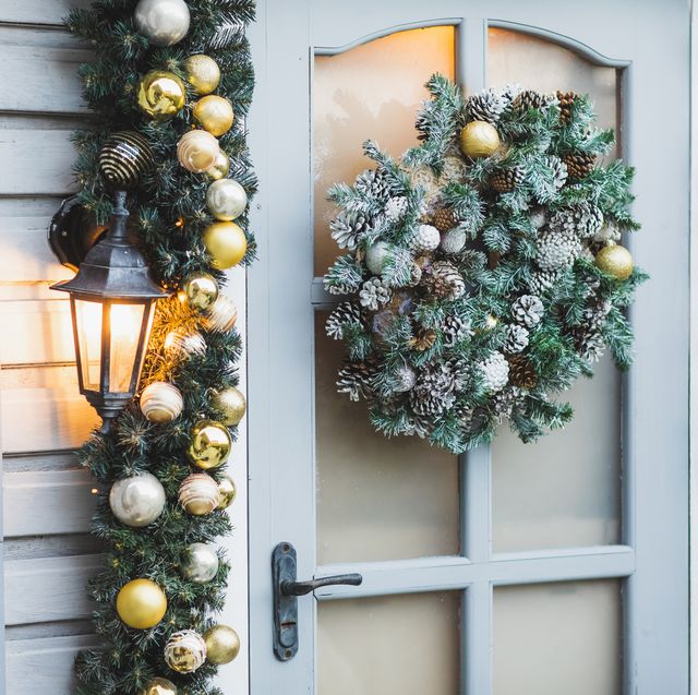 winter rustic entrance door decorated for new year and christmas with ornaments and christmas lights winter exterior of a country house with christmas decorations in rustic style christmas eve cozy home decor