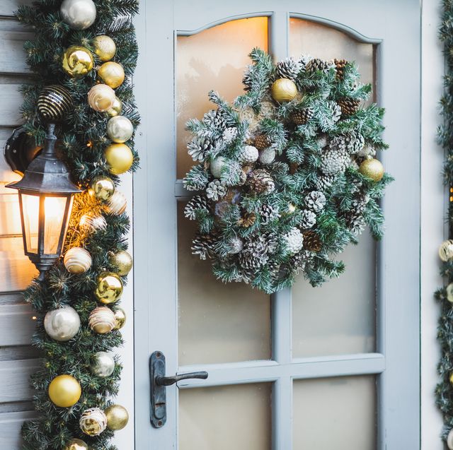 winter rustic entrance door decorated for new year and christmas with ornaments and christmas lights winter exterior of a country house with christmas decorations in rustic style christmas eve cozy home decor