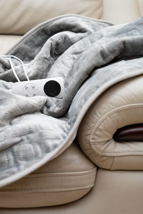 electric blanket with controller on a sofa vertical composition