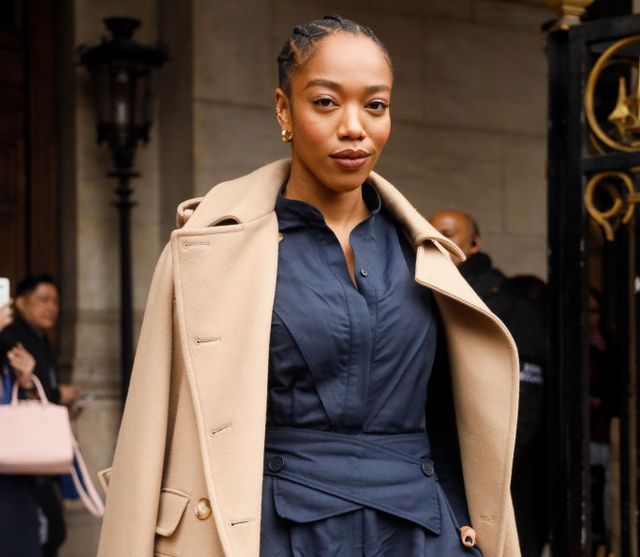 paris, france march 02 naomi ackie wearing stella mccartney trench coat, navy shirt green stilettos and baby blue leather bag outside stella mccartney during paris fashion week womenswear fallwinter 20202021 day eight on march 02, 2020 in paris, france photo by hanna lassengetty images