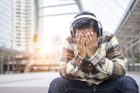 man listening to sad music unhappy lonely in the city