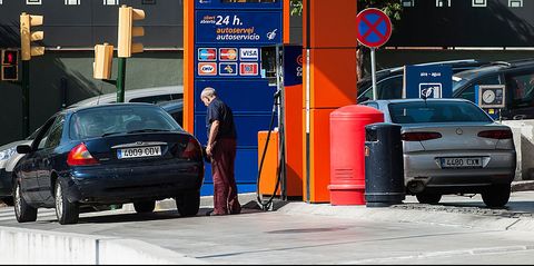 a customer refuels his vehicle at a self service fuel pump on the forecourt of a new campsa express gas station, operated by repsol sa, in montmelo, spain, on friday, aug 2, 2013 the low cost gas stations may offer discounts and will keep costs at minimum photographer david ramosbloomberg via getty images