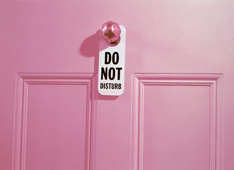 'Do not disturb' sign hanging from door handle