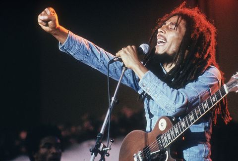 jamaican reggae musician, songwriter, and singer bob marley performs on stage, in a concert at grona lund, stockholm, sweden he extends his fist as he sings into the microphone, with an electric guitar   photo by hulton archivegetty images
