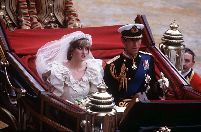 prince charles, prince of wales and diana, princess of wales, wearing a wedding dress designed by david and elizabeth emanuel and the spencer family tiara, ride in an open carriage, from st pauls cathedral to buckingham palace, following their wedding on july 29, 1981 in london, england photo by anwar husseingetty images